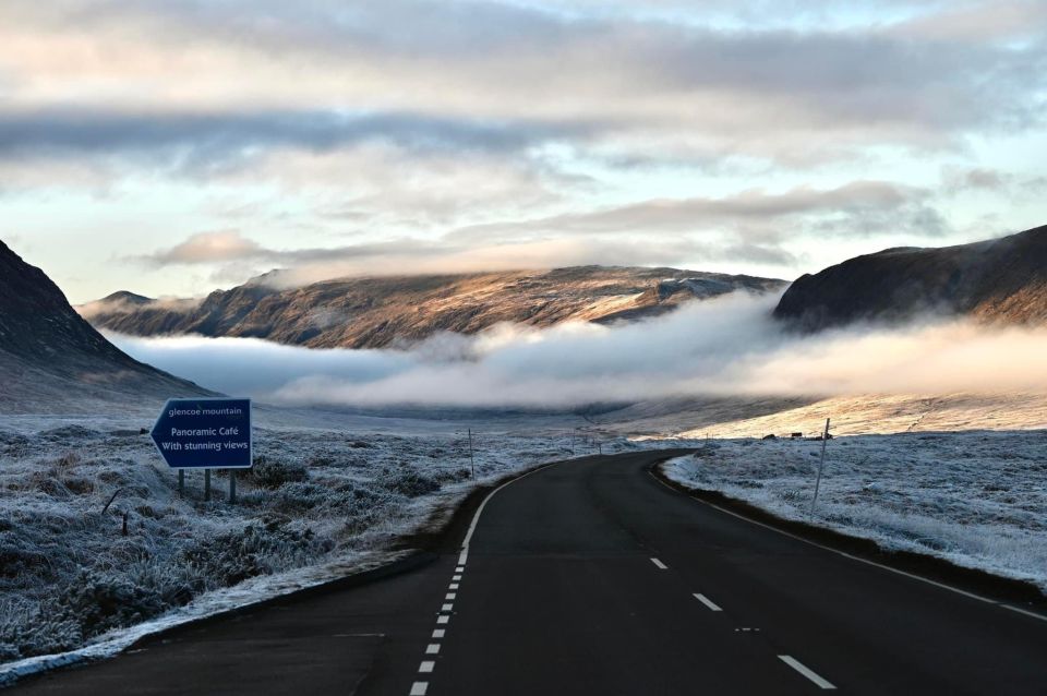 From Edinburgh: The Kelpies, Glencoe & Loch Lomond Day Tour - Kilmahog: feeding Highland cows in a real working-mood moment